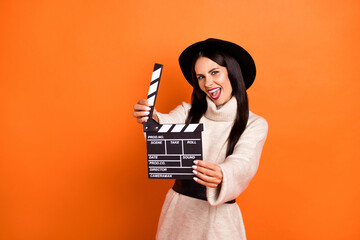 Portrait of beautiful gorgeous cheerful woman holding clapper action having fun isolated over...
