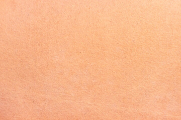 The surface of an old worn cardboard sheet. Light paper neutral texture.