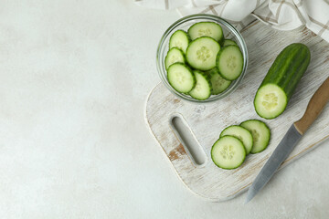 Concept of ripe vegetable with cucumbers on white textured table