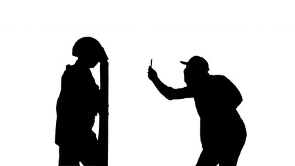 Silhouette Aggressive protester shooting riot police on smartphone.