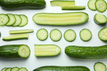 Flat lay with ripe cucumbers on white background