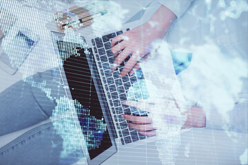 Double exposure of woman hands working on computer and financial theme hologram drawing. Top View. Business concept.