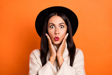 Portrait of attractive amazed woman incredible news reaction pout lips isolated over bright orange color background