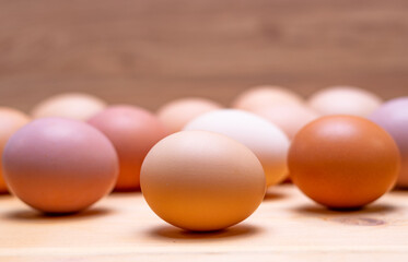 Close-up view of raw chicken eggs. Egg On Brown wooden background