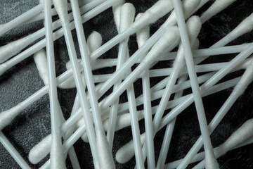 Cotton swabs on black smoky background, close up