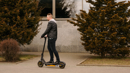 Modern man riding electric scooter in the city