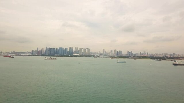 Sped up drone shot of Singapore anchorage and city skyline