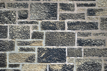 Close Up of Rough Textured Stoines in Dirty Masonry Wall