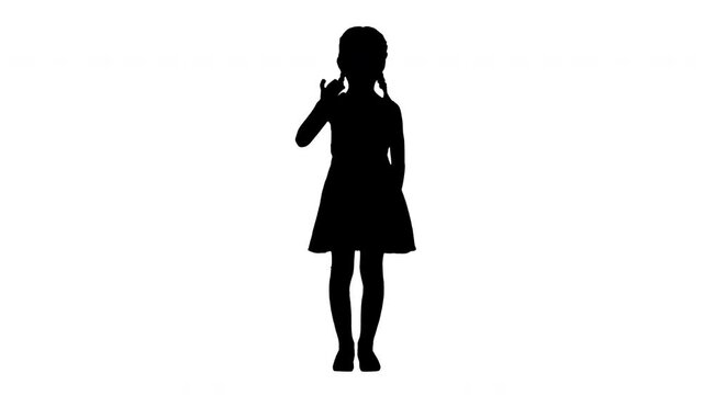 Silhouette Beautiful brunette little girl in polka dot dress waving to the camera.