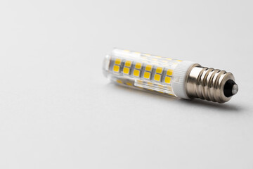 Light bulb on light grey paper background