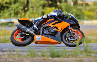 Motorcycle practice leaning into a fast corner on track