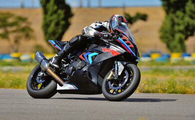 Motorcycle practice leaning into a fast corner on track