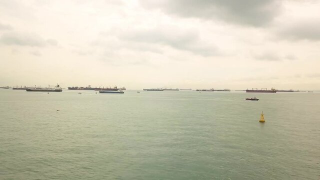 Sped up drone shot of boats moving in Singapore anchorage