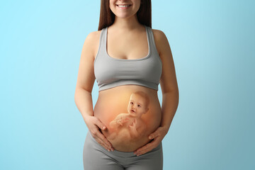 Pregnant woman and baby on light blue background, closeup view of belly. Double exposure