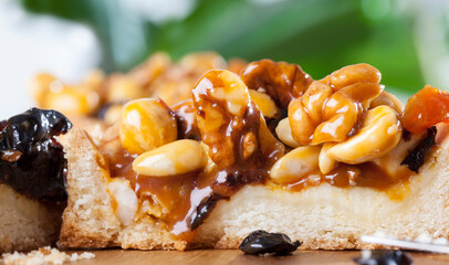 round tartlet with nuts and dried fruits poured with caramel