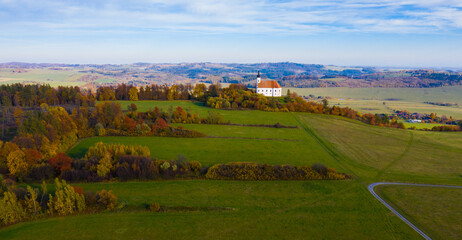 Fototapeta na wymiar Scenic autumn landscape with small Roman Catholic church on hilltop, Czech Republic..