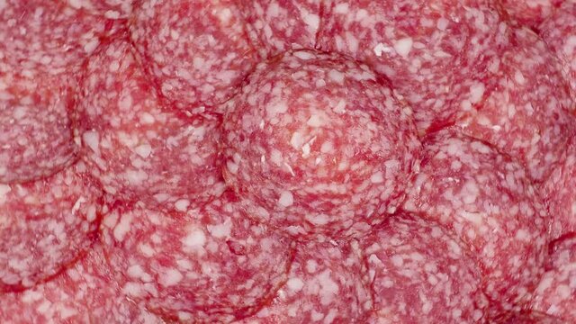 Slices of salami  background. sausage cut. uncooked smoked.  