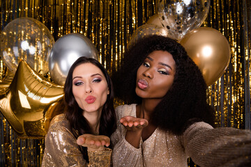 Photo of optimistic brunette ladies blow kiss do selfie wear nice dresses isolated on bright gold color background