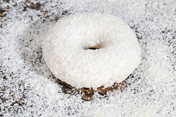 a fresh doughnut covered with white chocolate and coconut
