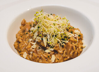 Un tipico risotto italiano con arroz cremoso, vegetales y queso parmesano