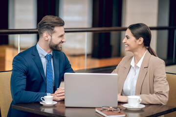 Business partners sitting at the table and having a talk