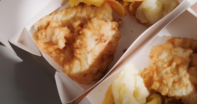 Top view of traditional Greek fried cod fish in card boxes for delivery, mediterranean cuisine, Greece March 25 food tradition. 