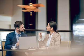 Business partners sitting at the table and discussing the project