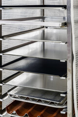 empty metal molds, trays and racks for baking bread and bakery products in a bakery