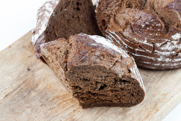 black rye bread divided into parts, fresh and soft