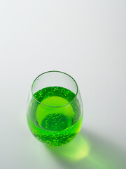 Cup with tarragon drink on white background.