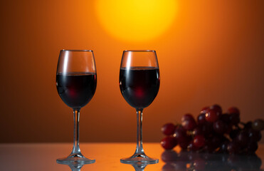 Two glasses of red wine on a beautiful sunset background. holiday mood