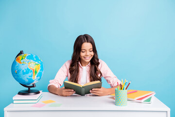 Photo of young pretty charming happy positive girl enjoying reading book homework isolated on blue color background