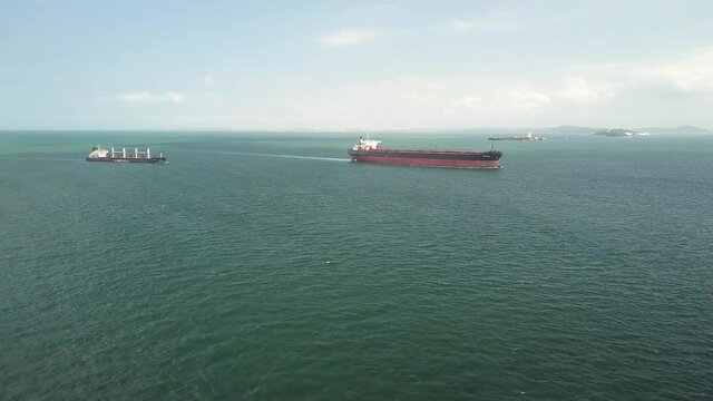 Drone shot of two bulk carriers sailing Singapore Straits
