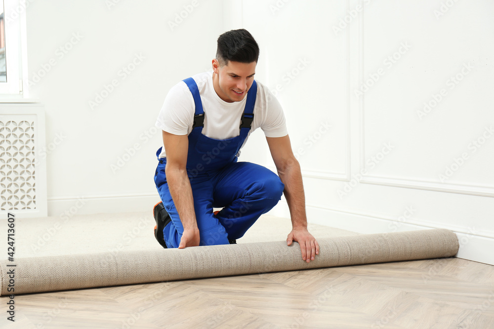 Canvas Prints Worker rolling out new carpet in room