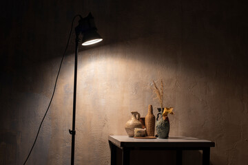 still life with a clay jug of squash and squash in the dark under lamp light