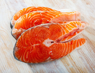 Raw red fish salmon fillet on wooden background