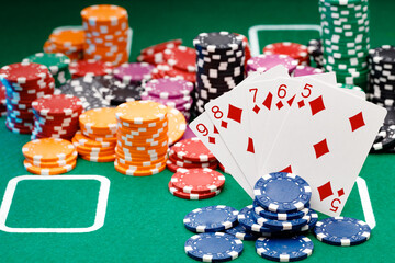 Playing cards and chips on green casino table background