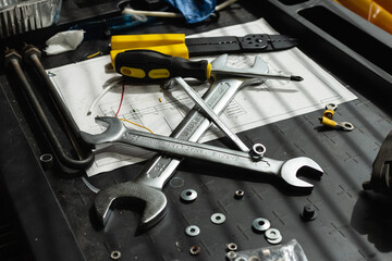 Messy set of tools on a working table in a garage