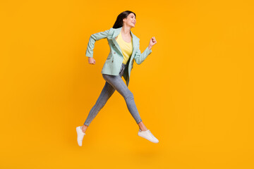 Fototapeta na wymiar Full size profile side photo of young attractive lovely pretty cheerful girl running fast isolated on yellow color background