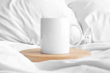 Fototapeta na wymiar White mug mockup on the bed.