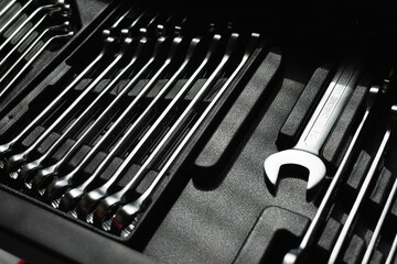 Set of wrenches in a black toolbox