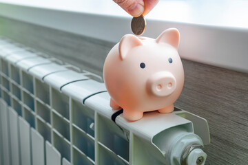concept of paying for heating in homes with a cold climate. Cash money is lying on a white metal...