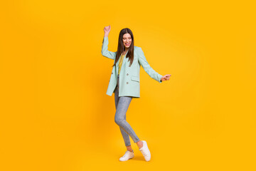 Full size photo of young happy positive lovely pretty girl dancing enjoying free time isolated on yellow color background