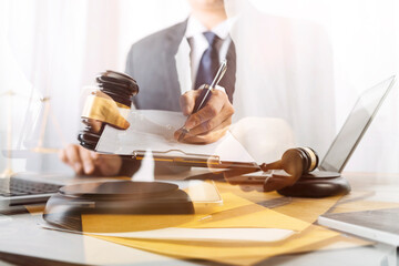 Business and lawyers discussing contract papers with brass scale on desk in office. Law, legal services, advice, justice and law concept picture with film grain effect