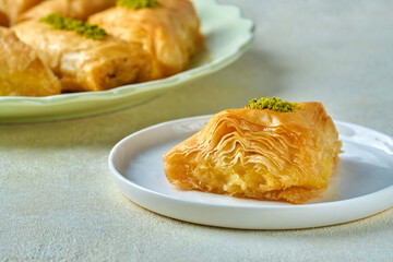Sweets arabic dessert baklava, , kunafa, kadayif with pistachio nuts and cheese . Closeup