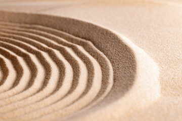 Fototapeta na wymiar Zen pattern in yellow sand, close up.
