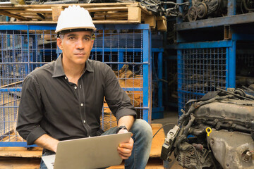 Engineer man working, Caucasian manager using laptop and looking straight in factory-warehouse