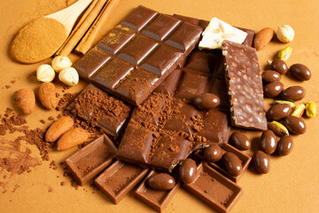 White and milk chocolates. Almond, pistachio, hazelnut.. background, texture..