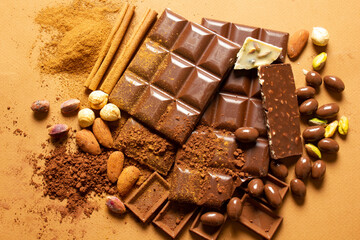 White and milk chocolates. Almond, pistachio, hazelnut.. background, texture..