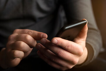 Young businessman holding and using smart phone dialing touch screen cell phone in office. business, lifestyle, technology and social media network concept